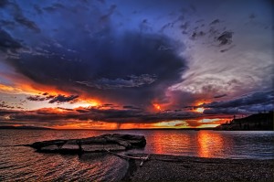 The sun casts a dramatic glow over Yellowstone Lake. (photo ©Leon Jenson — click to enlarge)