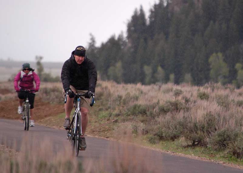 Bicyclists pedal through a mix of snow and freezing rain south of Moose Wednesday on a newly opened segment of the multipurpose pathway in Grand Teton National Park. (Ruffin Prevost/Yellowstone Gate - click to enlarge)