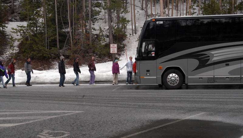 Middle school students visiting Yellowstone Park from Utah board their bus after stopping at Artist Point in this 2012 file photo.