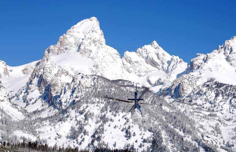 A helicopter heads toward Garnet Canyon in April 2011 during a search for two lost skiers in Grand Teton National Park. (National Park Service file photo by Jackie Skaggs - click to enlarge)