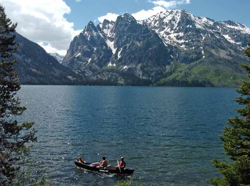 A group paddles a canoe on Jenny Lake in Grand Teton National Park. (Ruffin Prevost/Yellowstone Gate file photo - click to enlarge)