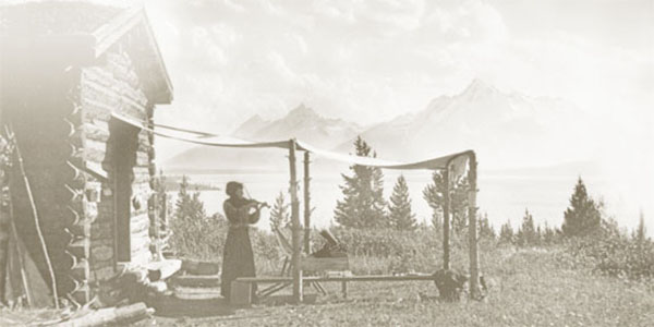 Edith Sargent playis the violin outside of Merymere Lodge at the site of the AMK Ranch in Grand Teton National Park.