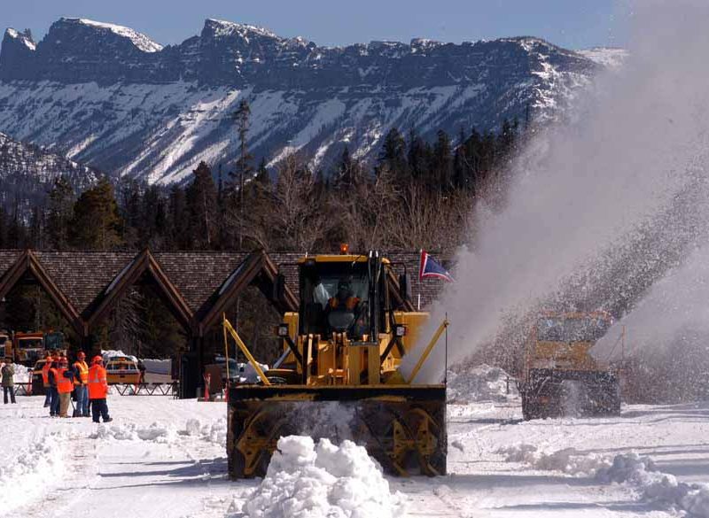 Workers look on as two rotary snowplows enter Yellowstone National Park on Monday to begin removing snow along the East Entrance Road. (Ruffin Prevost/Yellowstone Gate - click to enlarge)