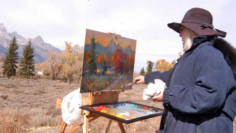 Idaho resident Elesa Shuman paints the Tetons amid fall colors as viewed from the Dornan's parking lot in Grand Teton National Park in this October 2012 file photo.