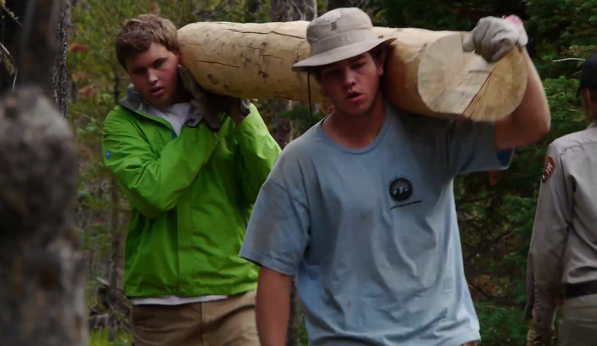 Participants in the Grand Teton National Park Youth Conservation Program move a log during a trail project.