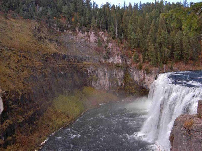 Mist from Upper Mesa Falls in the Caribou-Targhee National Forest in Idaho keeps the surrounding area green despite fall colors emerging across the region.