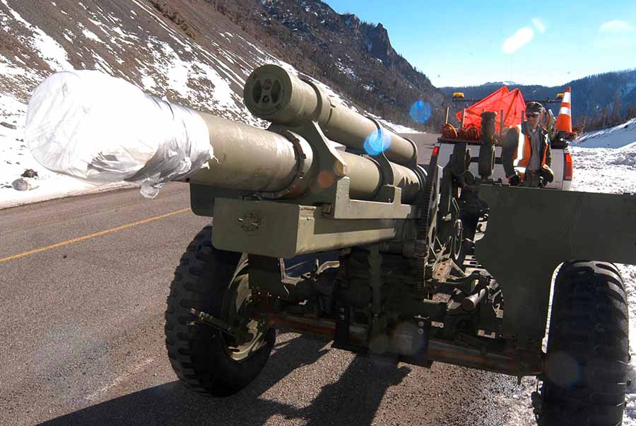 Yellowstone National Park maintenance worker Eric Holdren works last month to prepare a howitzer for use this winter in avalanche mitigation along Sylvan Pass. (Ruffin Prevost/Yellowstone Gate)