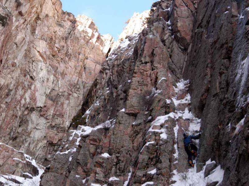 A climber looks for the best route up a rock face in Shoshone Canyon on Saturday during the 16th Annual Cody Ice Climbing Festival in Cody, Wyo.