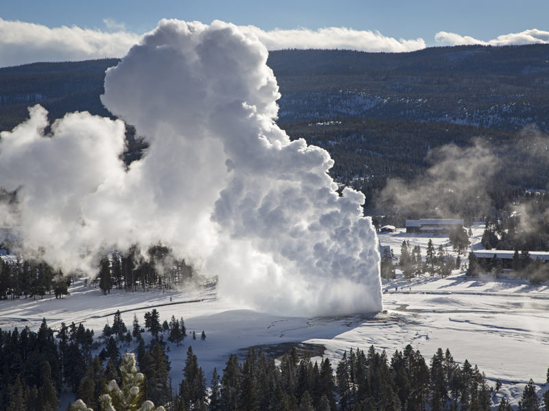 Rising steam from Old Faithful hangs in the frigid air as seen from Observation Point in Yellowstone National Park during February 2014 cold snap.