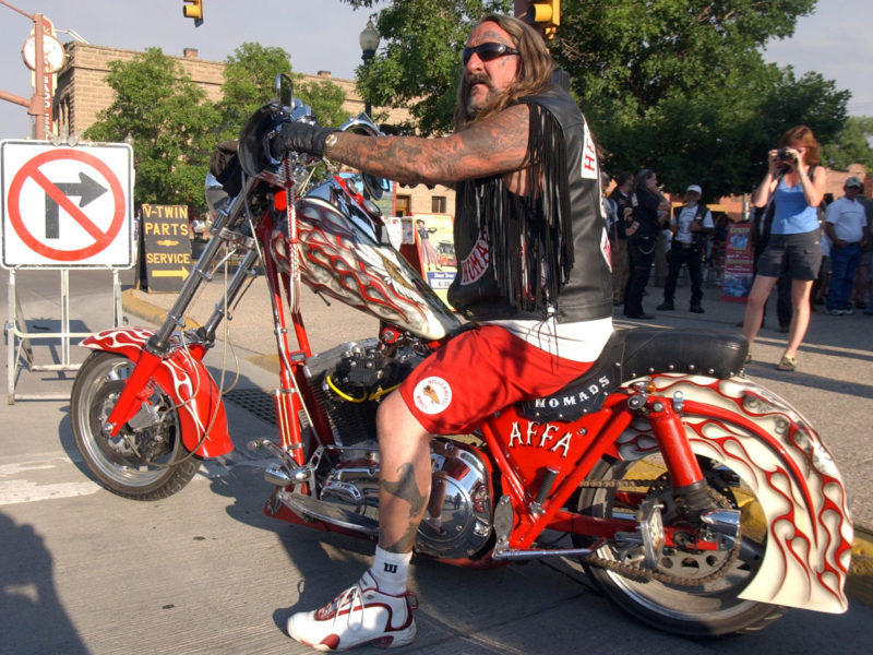 A Hells Angels member from Arizona checks traffic during the 2006 World Run in Cody, Wyo. before pulling onto Sheridan Avenue.