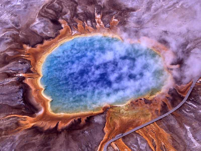 Grand Prismatic Spring is the largest hot spring in Yellowstone National Park. Its colors are the result of different forms of microbial life thriving in different temperature zones.