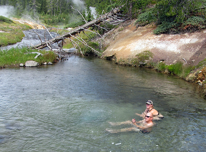 Alyssa Ammen and Ben Griffith soak in Mr. Bubbles in Yellowstone National Park. Mr.Bubbles is one of the rare places you can soak in Yellowstone because it’s not a thermal feature. Hot water from thermal features nearby mixes with the cold river water.