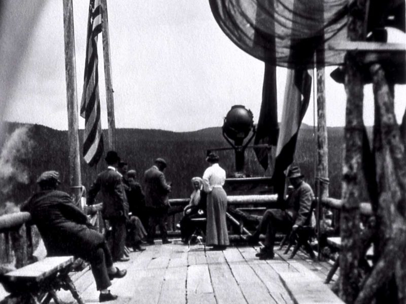 Visitors take in the view from atop the Old Faithful Inn in this undated Yellowstone National Park archival photo, likely from around 1910.