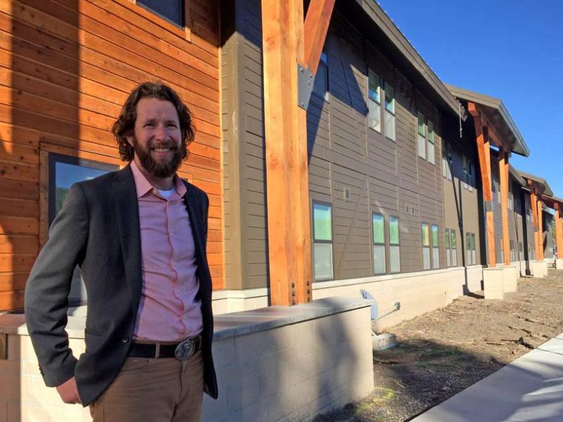 Dylan Hoffman, director of environmental affairs in Yellowstone for Xanterra Parks and Resorts, stands near the entrance to Paintbrush Lodge, a newly completed employee dormitory in Yellowstone National Park.