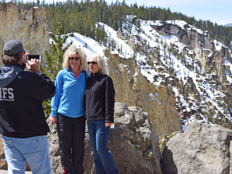 Jacob Baisley, who recently quit his job and sold his house to travel to national parks, snaps a photo May 4 of two Yellowstone National Park visitors at Artist Point.