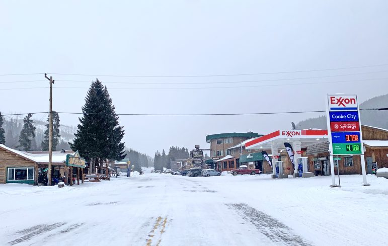 A view looking a half-mile east along U.S. Highway 212 from the center of Cooke City, Montana ends at the edge of an 8-mile section of road left unplowed in winter to benefit snowmobile riders. Most residents are asking government officials in Montana and Wyoming to plow the road year-round. (Ruffin Prevost/WyoFile)
